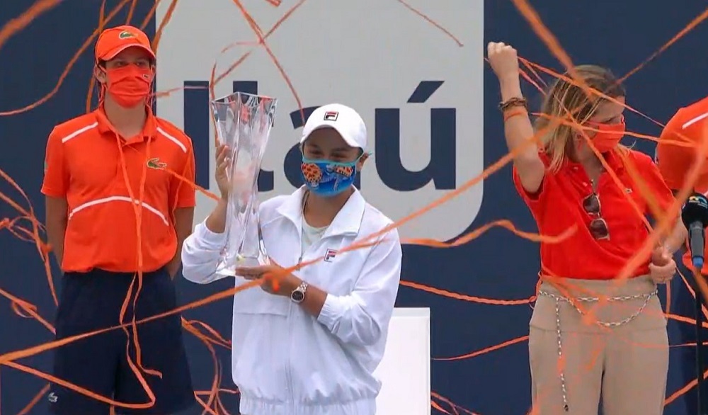 Streamers surround Ash Barty and the Miami trophy