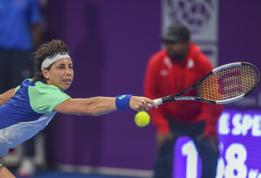 Suarez Navarro stretches for a backhand in Doha