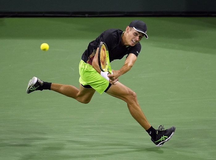 Alex de Minaur chases down a backhand