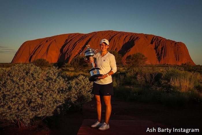 Ash Barty at Uluru in Central Australia with the Australian Open trophy